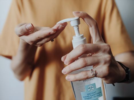 Canva - Woman pumping hand sanitizer from a bottle.jpg